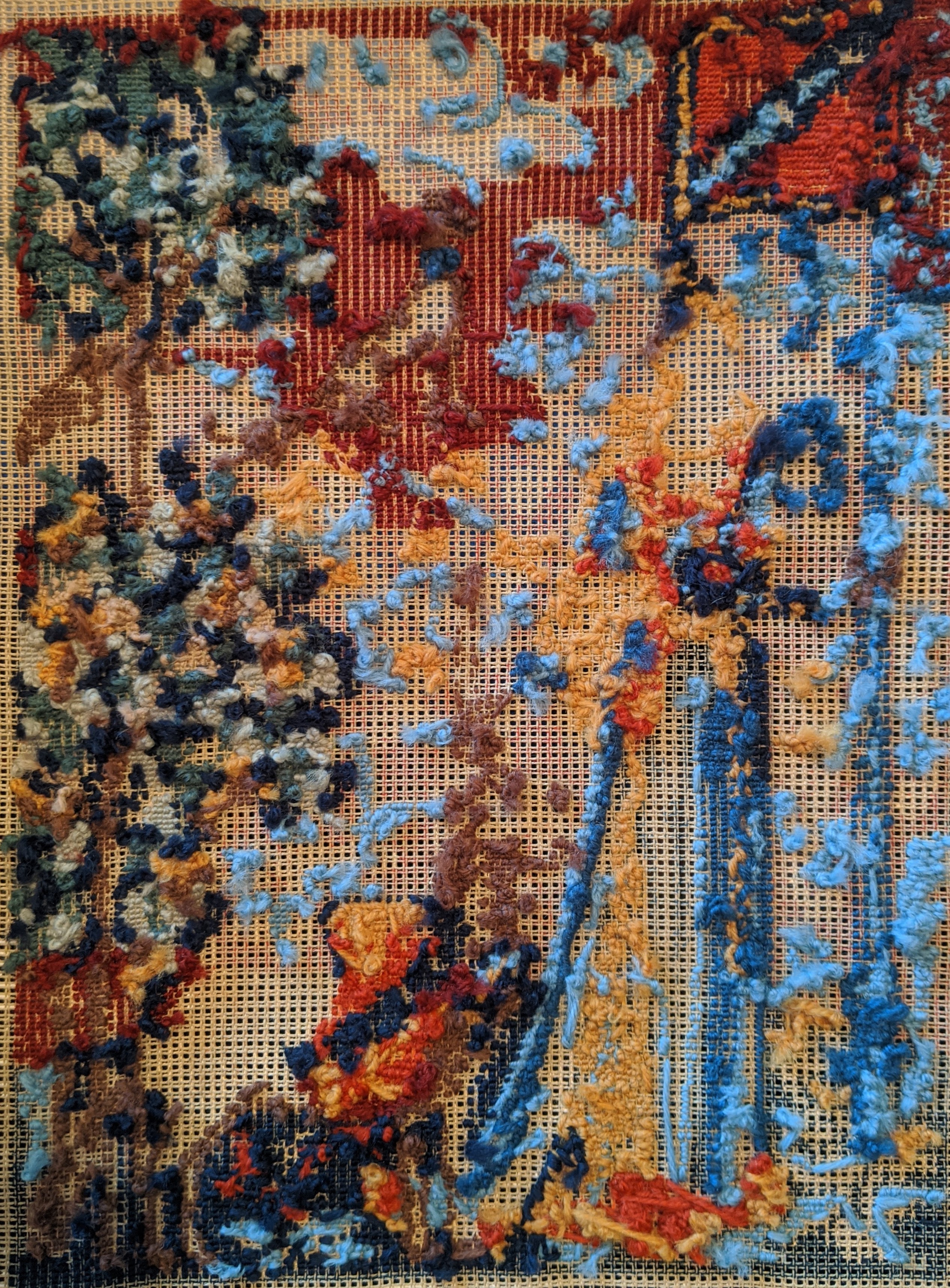 The back of the tapestry. A light red area in the top right is completely covered, whereas the dark red in the middle has columns of color with the canvas showing through in the middle.